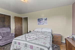 Bedroom featuring light wood-style floors and baseboards