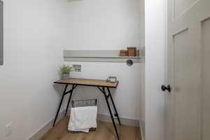 Home office featuring wood finished floors and baseboards