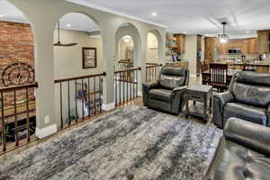 Living area featuring recessed lighting, a ceiling fan, light wood-style floors, and baseboards