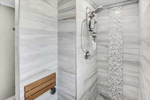 Full bath featuring tiled shower
