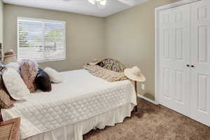 Bedroom with carpet flooring, a closet, and ceiling fan