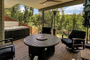 Wooden terrace featuring ceiling fan