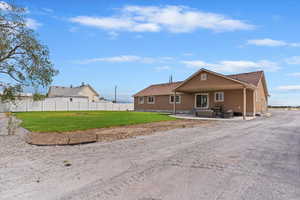 View of front of home featuring a patio area and stucco siding