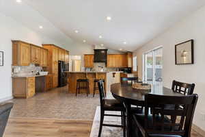 Dining area with vaulted ceiling and recessed lighting