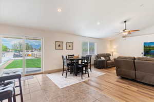 Dining room featuring a ceiling fan, light tile patterned flooring, vaulted ceiling, and recessed lighting