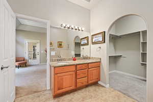 Full bath with tile patterned flooring, double vanity, and baseboards