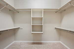Spacious closet with carpet floors