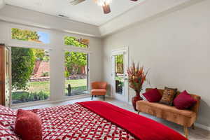 Carpeted bedroom featuring multiple windows, access to exterior, baseboards, and a ceiling fan