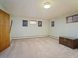 Basement with a baseboard radiator and baseboards