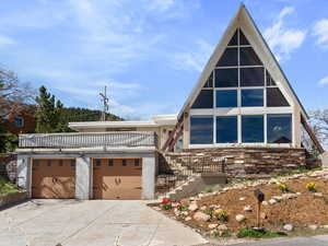 View of front of property featuring concrete driveway and an attached garage