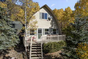 Rear view of property featuring a wooden deck