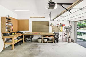 Garage with a workshop area and a garage door opener