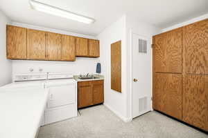 Laundry room featuring cabinet space, independent washer and dryer, and baseboards