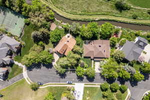 Aerial overview of property's location featuring a nearby body of water and nearby suburban area