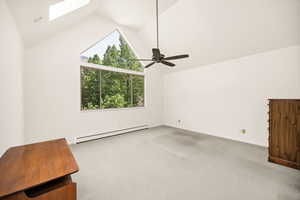 Additional living space with baseboard heating, lofted ceiling, a skylight, plenty of natural light, and carpet flooring