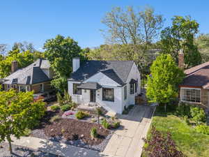 View of front of house featuring driveway, xeriscaped yard, and new roof