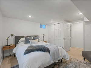Carpeted bedroom featuring recessed lighting, a closet, and baseboards