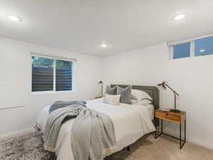 Carpeted bedroom featuring recessed lighting and baseboards