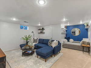 Living room featuring carpet floors, baseboards, and recessed lighting