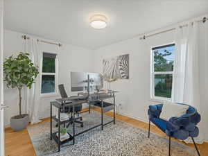 Home office with wood finished floors and baseboards