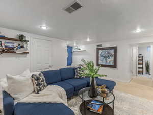 Living area featuring carpet, recessed lighting, and baseboards