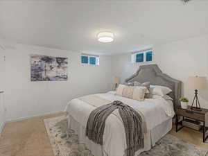 Bedroom featuring light colored carpet and baseboards