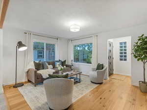 Living area with light wood-style flooring and baseboards