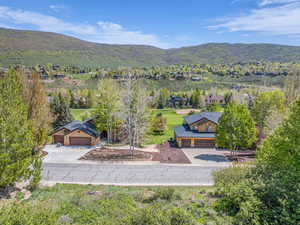 Aerial view of property and surrounding area with mountains