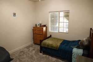 Carpeted bedroom featuring baseboards
