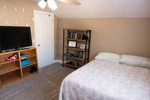 Carpeted bedroom featuring ceiling fan