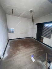 Unfurnished living room with baseboards and wood finished floors
