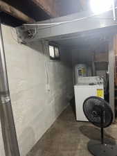 Unfinished basement with water heater and washer / dryer
