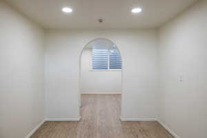 Spare room featuring wood finished floors, baseboards, recessed lighting, and a smoke detector