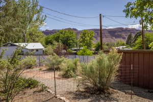 View of yard featuring fence and a mountain view