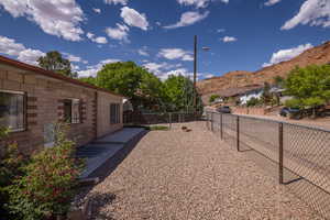 Fenced backyard with a mountain view
