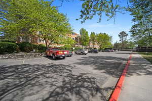 View of asphalt road with curbs and sidewalks