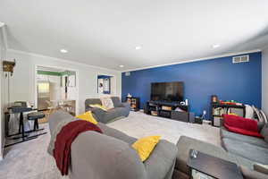 Living room with carpet flooring, crown molding, and recessed lighting