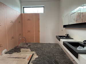 Kitchen with a sink and stone floors