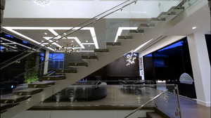 Stairway featuring a chandelier and recessed lighting