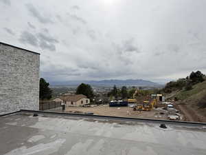 Exterior space featuring a residential view, a balcony, and a mountain view