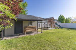 View of yard with a playground and an outdoor structure