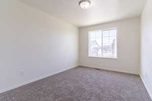 Unfurnished room featuring carpet floors and baseboards
