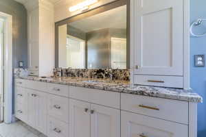 Bathroom with vanity and marble look tile flooring