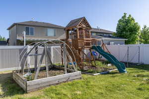 View of playground featuring a vegetable garden