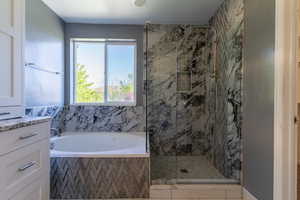 Bathroom with a shower stall and a garden tub