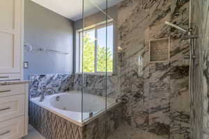 Full bath with a tub with jets and a marble finish shower