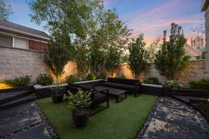 Fenced backyard with an outdoor living space and a patio