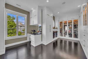 Kitchen with white cabinetry, dark wood-style flooring, recessed lighting, dark countertops, and baseboards