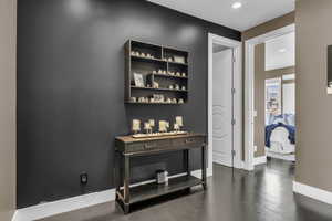Interior space with dark wood-style floors, baseboards, and recessed lighting