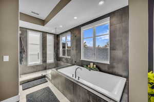 Bathroom with a bath, a shower stall, recessed lighting, and tile patterned floors